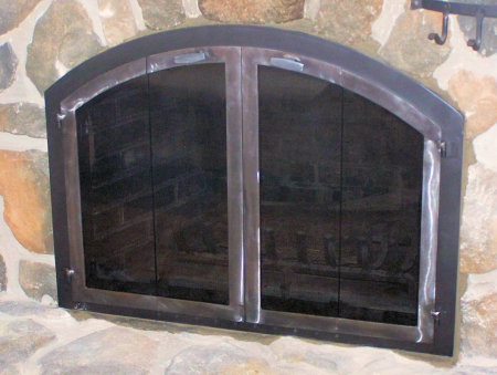 Nantucket Arch Black finish frame, natural iron finish vice bi fold doors, standard smoked   (Mortar installation on stone)